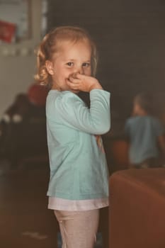 Little adorable girl posing for a portrait. Real people, authentic situations