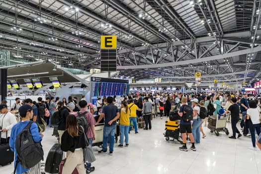 Bangkok, Thailand - April 10, 2023: Suvarnabhumi Airport with many travelers during the Songkran Festival because it is the Thai New Year which is a long holiday.There are many festivals in provinces.