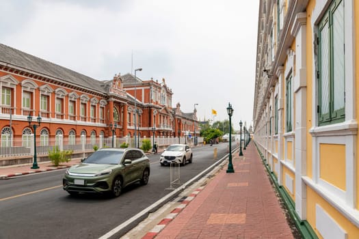 Bangkok,Thailand - April 16, 2023: The yellow building contrasts with the white stripes and has light green windows of Thailand's Ministry of Defense. A popular spot for tourists to take pictures.