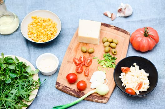 Preparing healthy snacks with fresh cheese and vegetables