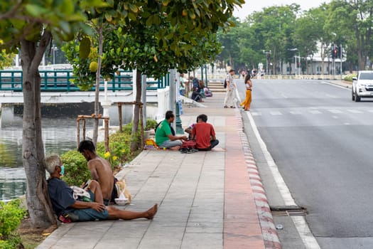 Bangkok,Thailand - April 16, 2023: If coming to Bangkok, you will be able to see homeless people resting on the sidewalks along the Khlong Lot. in front of Rattanakosin Hotel, Ratchadamnoen Road