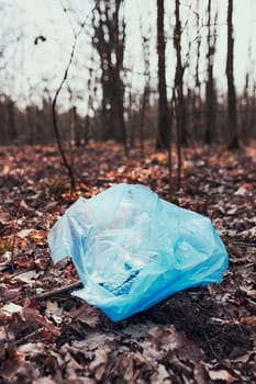 Plastic waste left in forest. Concept of plastic pollution and irresponsibility for environment. Environmental issue. Environmental damage. Real people, authentic situations