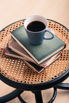 A few books with cup of coffee on chair