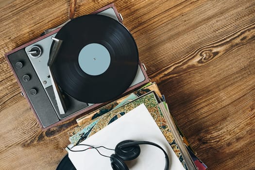 Listening to music from vinyl record. Playing music from analog disk on turntable player. Enjoying music from old collection. Relaxing at home. Retro and vintage. Audio stereo equipment. Analog sound. Ready for content