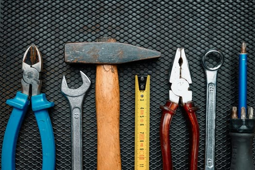 Hardware tools wrench screwdriver tape hammer on steel surface. Mechanic tools for maintenance. Hardware tools to fix. Technical background with copy space