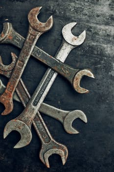 Spanners on steel surface. Old rusty wrenches for maintenance. Mechanic hardware tools to fix. Technical tools background with copy space