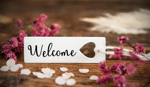 Natural Background With Purple Blossoms and Label With the English Word Welcome, Summer or Autumn Decoration