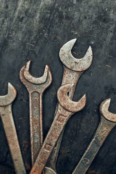 Spanners on steel surface. Old rusty wrenches for maintenance. Mechanic hardware tools to fix. Technical tools background with copy space