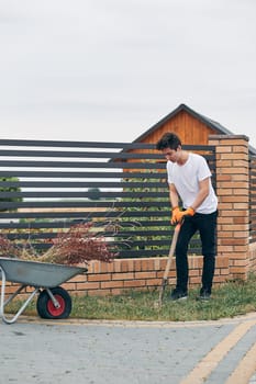 Teenage boy planting the plants, working at a home garden. Candid people, real moments, authentic situations