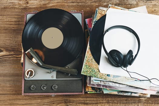 Listening to music from vinyl record. Playing music from analog disk on turntable player. Enjoying music from old collection. Relaxing at home. Retro and vintage. Audio stereo equipment. Analog sound