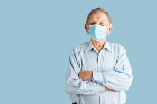 Old aged senior male patient with face mask. Wearing coronavirus covid-19 protection medical mask during the pandemic
