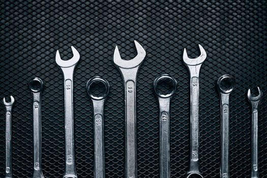 Set of chrome wrenches on steel surface. Mechanic tools for maintenance. Hardware tools to fix. Technical tools background