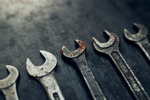 Spanners on steel surface. Old rusty wrenches for maintenance. Mechanic hardware tools to fix. Technical tools background with copy space