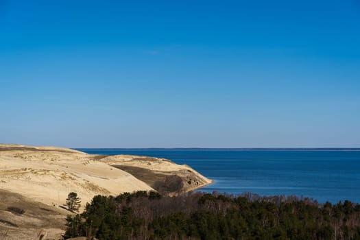 Baltic sea from Curonian Spit. The Gray Dunes, or the Dead Dunes is sandy hills with a bit of green specks at the Lithuanian side of the Curonian Spit.