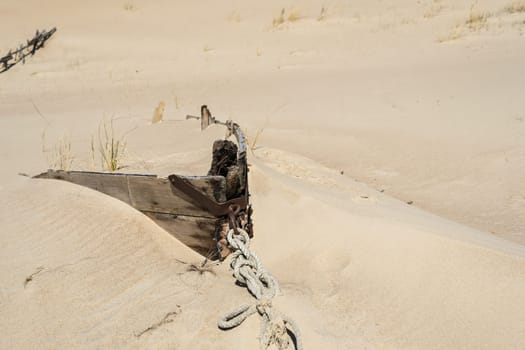 An old boat covered with sand in the Dead Dunes or Grey Dunes, Neringa, Lithuania, Curonian Spit.