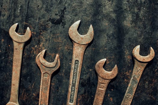 Spanners on steel surface. Old rusty wrenches for maintenance. Mechanic hardware tools to fix. Technical tools background with copy space