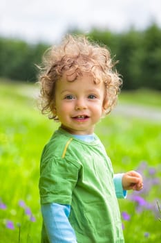 The portrait of a 1 and a half year old baby boy enjoying the outdoors.