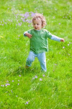 The portrait of a 1 and a half year old baby boy enjoying the outdoors.