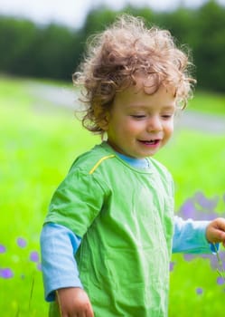 The portrait of a 1 and a half year old baby boy enjoying the outdoors.
