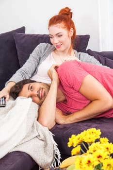 Young couple man wife relax on the couch in living room leisure at home