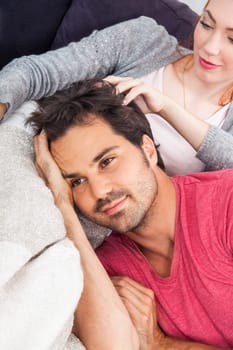 Young couple man wife relax on the couch in living room leisure at home
