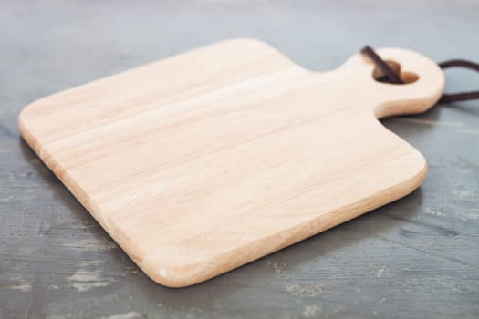 Wooden plate on gray background, stock photo