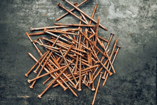 Rusty nails on steel surface. Tools for maintenance. Hardware tools to fix. Technical background with copy space