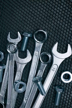 Set of chrome wrenches on steel surface. Mechanic tools for maintenance. Hardware tools to fix. Technical tools background