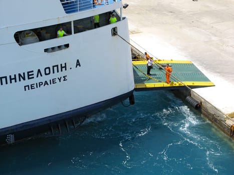 ISLAND OF TINOS, CYCLADES, GREECE - JULY 01, 2006: Agoudimos Lines ferry boat Penelope A crew preparing to set sail from Tinos island seaport
