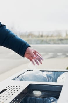 Man throwing a plastic bottle to trash. Plastic waste to recycling. Concept of plastic pollution and recycling plastic waste. Environmental issue. Environmental damage. Real people, authentic situations