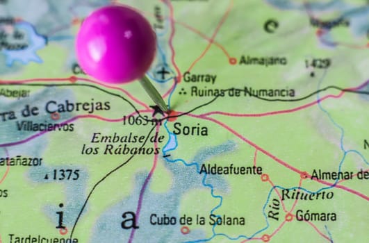 Pushpin marking on Soria, Spain. Selective focus on city