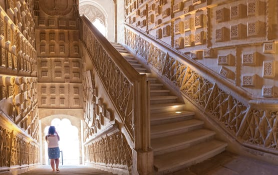 Valladolid Spain - July 18th 2020: San Gregorio College indoor stairs. Visitor woman taking pictures. Valladolid Spain