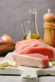 Closeup view of uncooked raw pork fillet with fat cut on slices