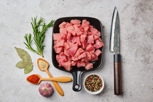 Top view of raw pork goulash in ceramic pan