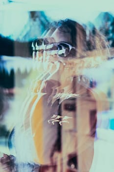Reflection in a window glass of woman which is talking on her mobile phone. Real people, authentic situations