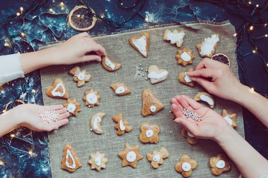 Decorating Christmas gingerbread cookies. View from above