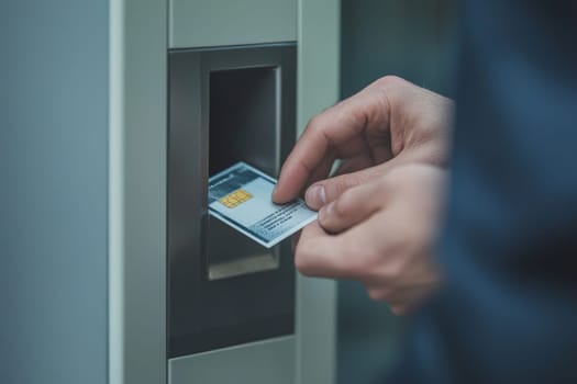 A hand inserting a card into a payment terminal while surrounded by a bustling urban environment filled with activity.