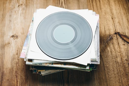 Stack of vinyl records. Listening to music from record. Playing music from analog disk. Retro and vintage. Audio stereo. Analog sound
