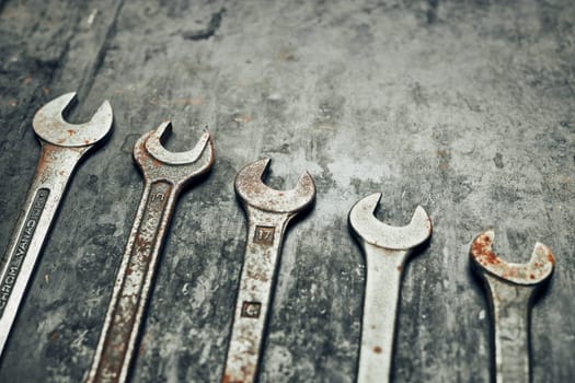 Spanners on steel surface. Old rusty wrenches for maintenance. Mechanic hardware tools to fix. Technical tools background with copy space