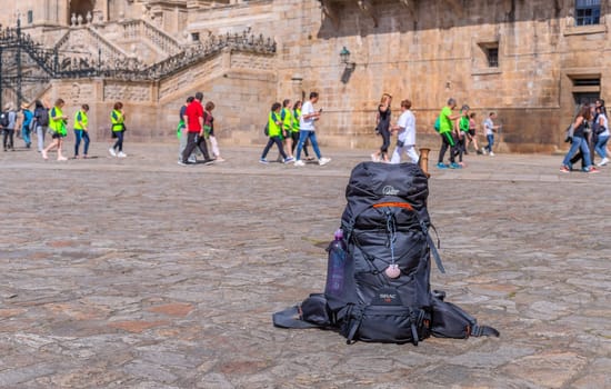 Santiago de Compostela, Spain: 08 April 2023: Pilgrim's backpack on the Way of Saint James (Camino de Santiago) at Saniago main square.