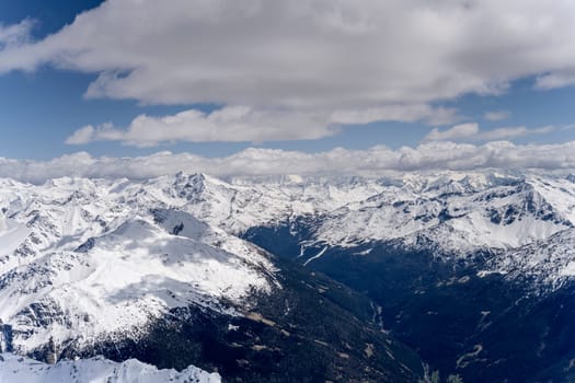 aerial landscape, from a glider plane, of Valfurva valley and Confinale peak and surrounding ranges under recent sping snow, shot from north in bright late spring light, Sondrio, Italy