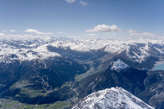 aerial landscape, from a glider plane, of high Valtellina valley and Vallecetta peak, shot from north east in bright late spring light, Sondrio, Italy