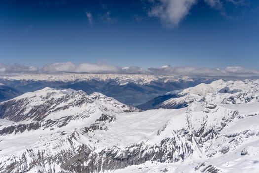 aerial landscape, from a glider plane, of Stelvio pass upland with Venosta valley in background, shot from west in bright late spring light, Sondrio, Italy