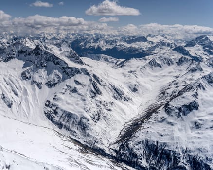aerial landscape, from a glider plane, of Campo valley and peak, shot from west in bright late spring light, Poschiavo, Switzerland
