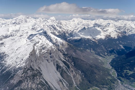 aerial landscape, from a glider plane, of Reit peak range, shot from west in bright late spring light, Sondrio, Italy