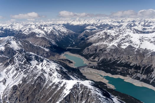 aerial landscape, from a glider plane, of S.Giacomo lake with Valbruna valley in background, shot from south west in bright late spring light, Sondrio, Italy