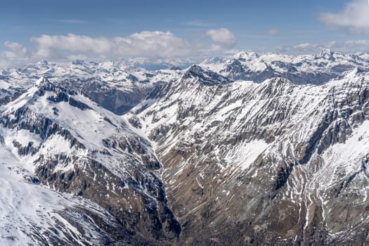 aerial landscape, from a glider plane, of Muretto mountain pass at Bernina range, shot from south in bright late spring light, Sondrio, Italy