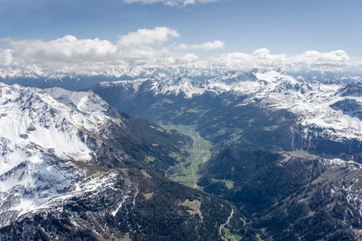 aerial landscape, from a glider plane, of Poschiavo valley, shot from north in bright late spring light, Poschiavo, Switzerland