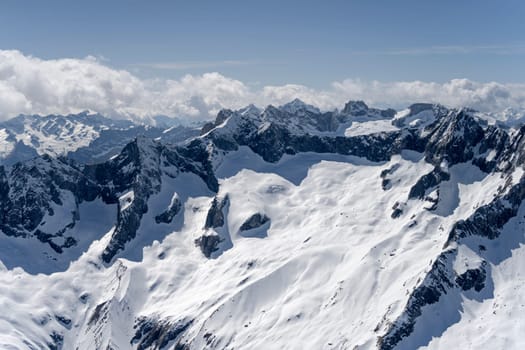 aerial landscape, from a glider plane, of Sissone peak steep snowy slopes, shot from south in bright late spring light, Sondrio, Italy