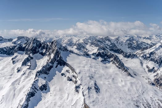 aerial landscape, from a glider plane, of Rosso peak steep snowy slopes, shot from south in bright late spring light, Sondrio, Italy
